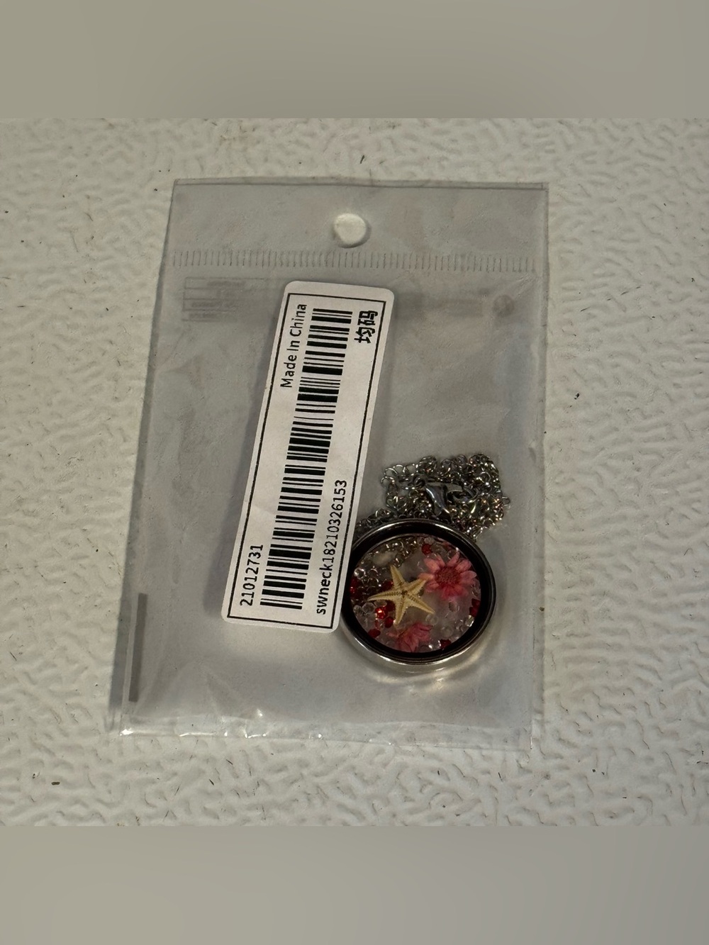 Silver Pendant Necklace with Pink Flower and Starfish Accent